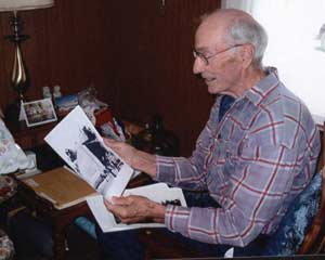 October 2005, Amos looking at print-out of Web site